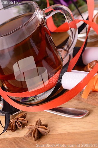 Image of hot tea with lemon and cinnamon on wooden backgroubd