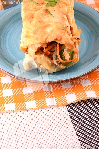 Image of Burrito with tomatoes and cheese on blue plate