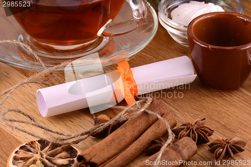 Image of tea cup with white paper and cinnamon