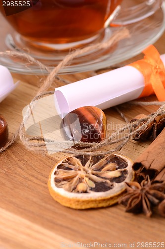 Image of hot tea with lemon and cinnamon on wooden backgroubd
