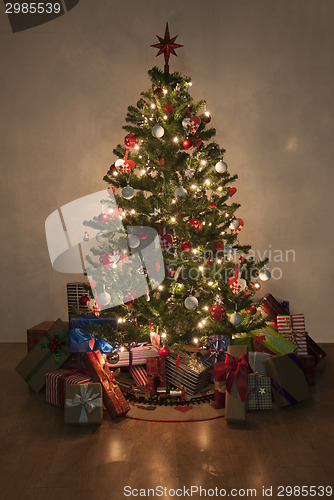 Image of illuminated christmas tree with presents