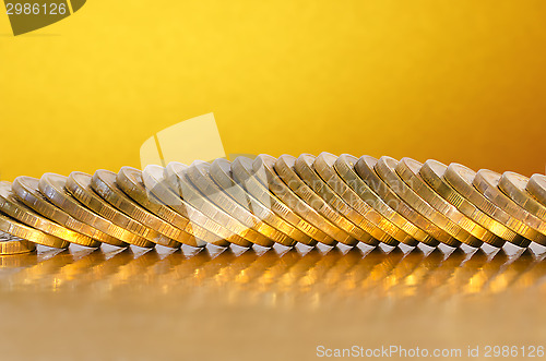 Image of Coins lying on the Golden surface with a Golden background
