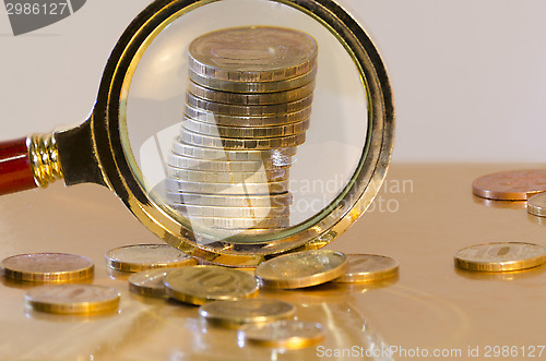 Image of A stack of coins under a magnifying glass