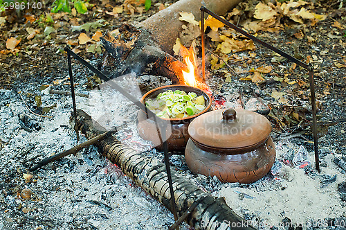 Image of Roast in a clay pot over charcoal