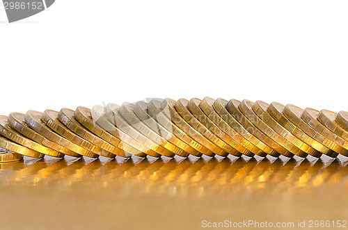 Image of A number of coins lying on the Golden surface