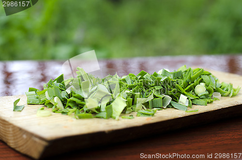 Image of Chopped green onions on a cutting Board