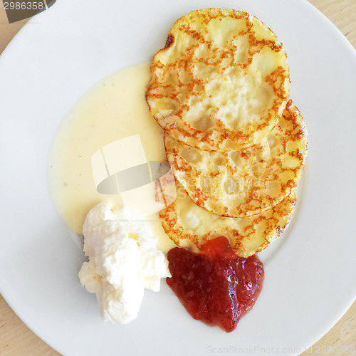 Image of Pancakes with vanilla sauce, cream and jam