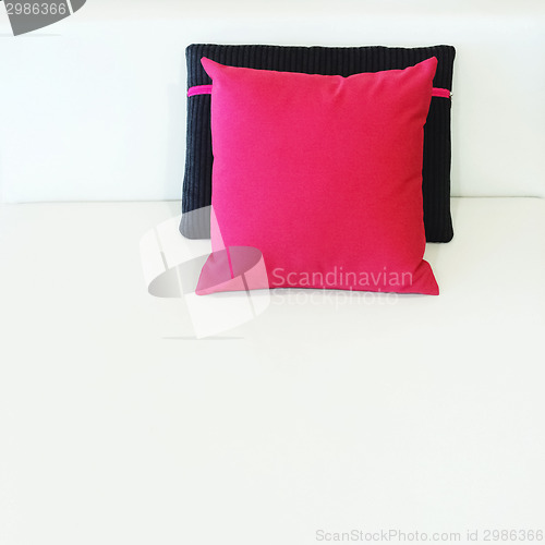 Image of Red and black cushions on a bed