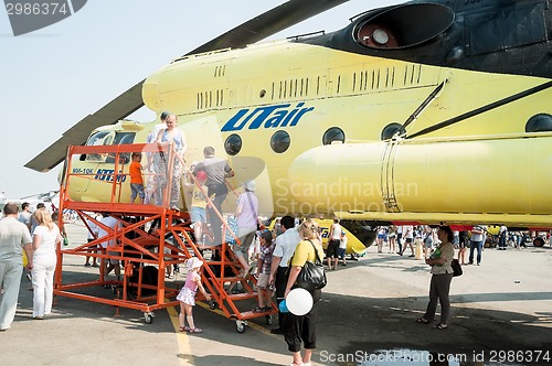 Image of People explore the MI-10K helicopter