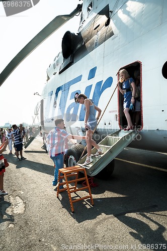Image of People exploring the MI-26T helicopter
