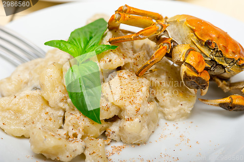 Image of Italian gnocchi with seafood sauce with crab and basil