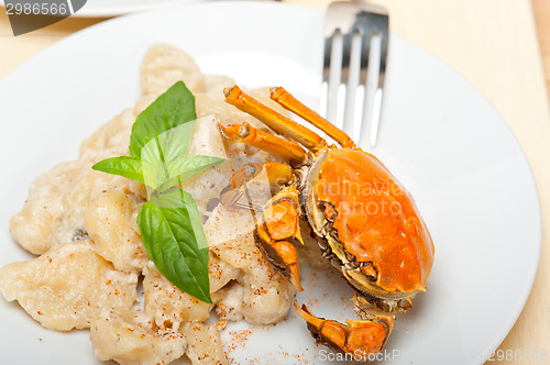 Image of Italian gnocchi with seafood sauce with crab and basil