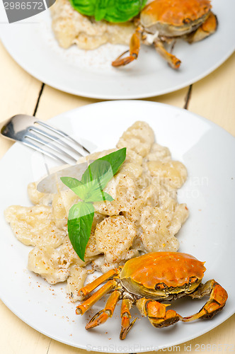 Image of Italian gnocchi with seafood sauce with crab and basil