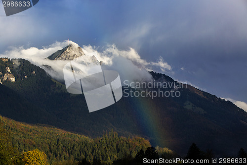 Image of Bavarian mountain Wendelstein with fog and rainbow