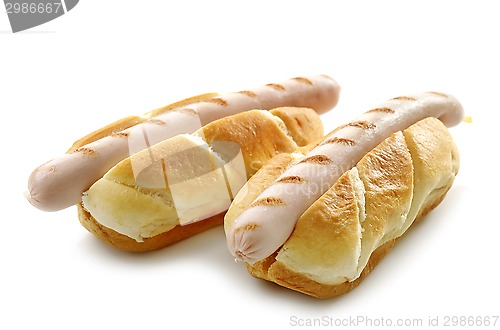 Image of two bread buns with grilled sausages