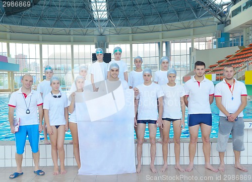 Image of children group  at swimming pool with empty white flag