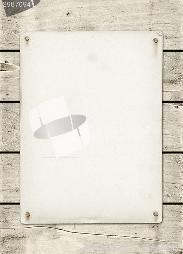 Image of Blank vintage poster nailed on a white wood board