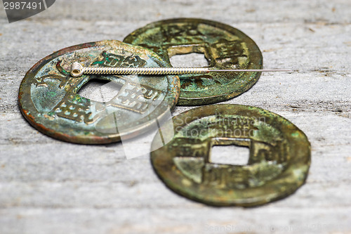 Image of acupuncture needle on chinese coins