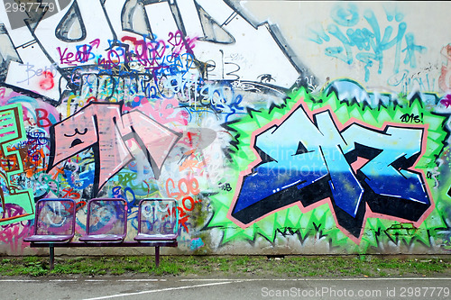 Image of Chairs in front of graffiti wall