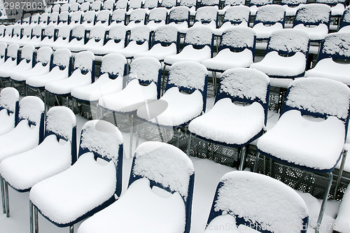 Image of Stadium chairs covered in snow