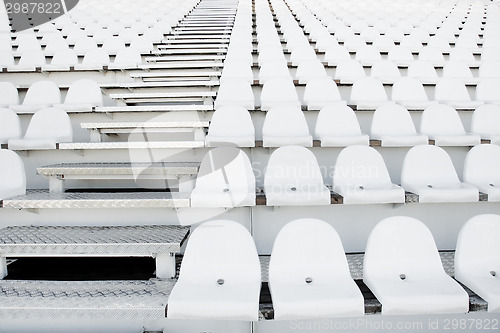 Image of White plastic chairs in rows