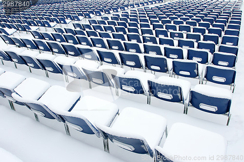 Image of Plastic chairs covered in snow