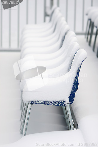 Image of Chairs covered with snow