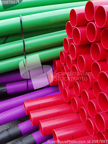 Image of Stacks of colorful plastic pipes