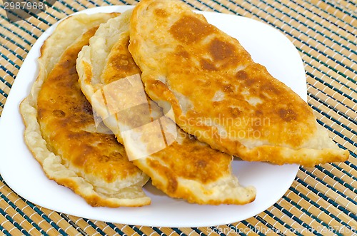 Image of Chebureks on the table on a white plate