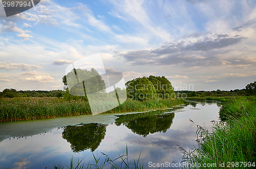 Image of Landscape with river bend and clouds reflected in the water