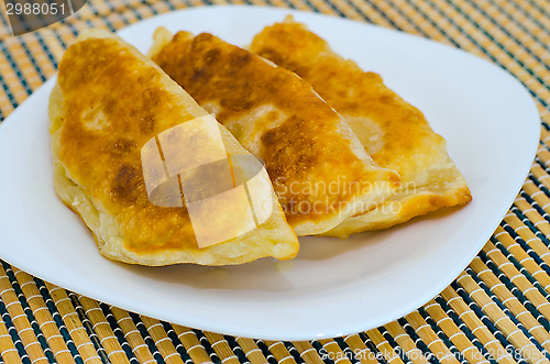 Image of Chebureks on the table on a white plate