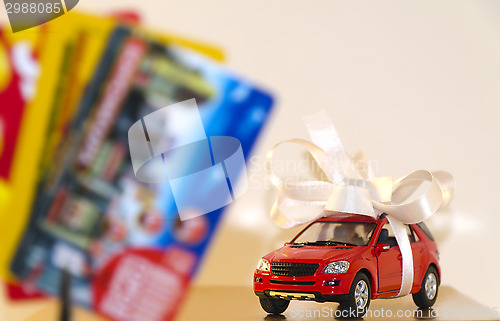 Image of Red machine in a white ribbon and discount cards
