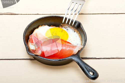 Image of egg sunny side up with italian speck ham