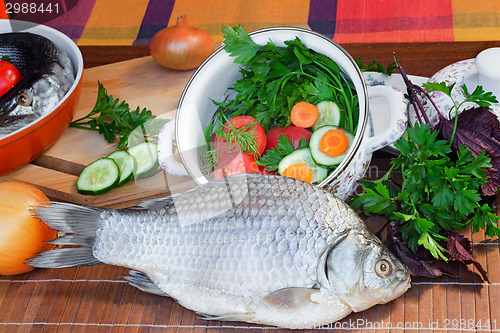 Image of Fish and components for her preparation: vegetables, spices, par