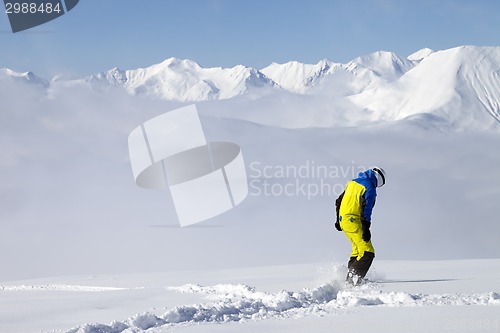 Image of Snowboarder on off-piste slope with new fallen snow