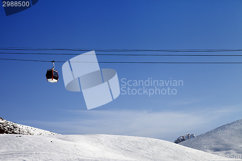 Image of Gondola lift and ski slope at sun day