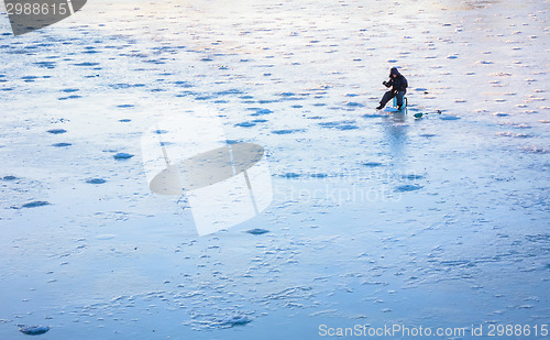 Image of Ice Fishing On Frost Lake In Winter Time