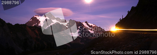 Image of Lone Car Passes on Roadway Full Moon Mt Shuksan