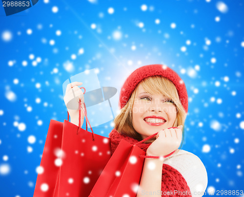 Image of smiling young woman with shopping bags