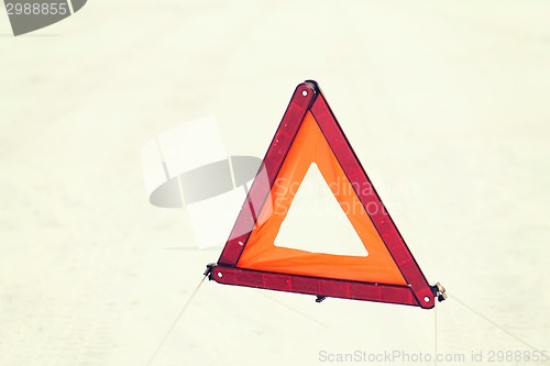 Image of closeup of warning triangle on snow