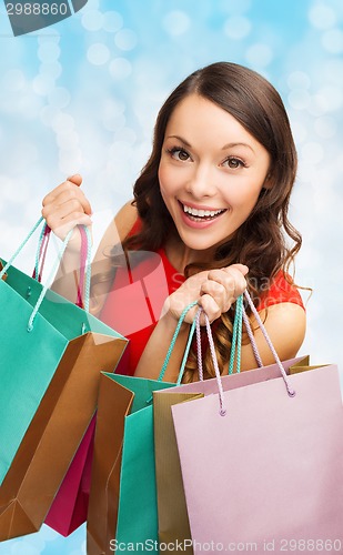 Image of smiling woman with colorful shopping bags