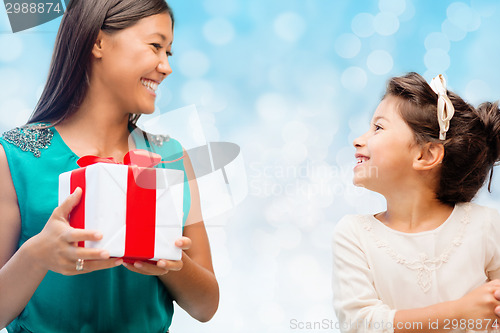 Image of happy mother and little girl with gift box