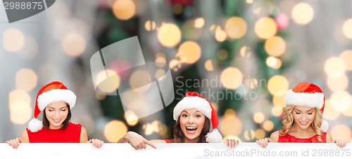 Image of women in santa helper hat with blank white board