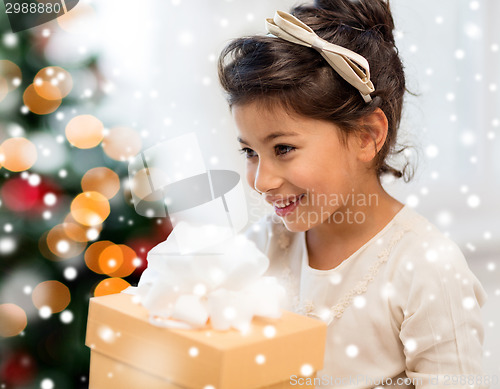 Image of smiling little girl with gift box