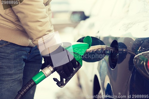 Image of close up of male refilling car fuel tank