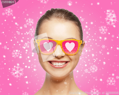 Image of smiling teenage girl in pink sunglasses