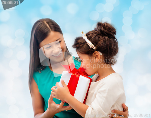 Image of happy mother and little girl with gift box