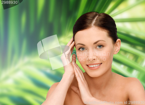Image of smiling young woman with bare shoulders