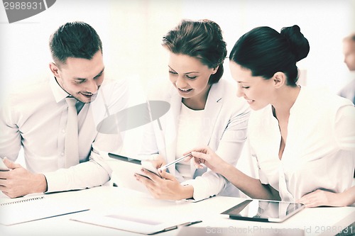 Image of business team working with tablet pcs in office