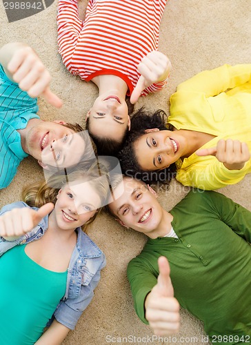 Image of group of smiling people lying down on floor